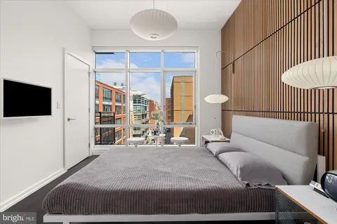 a bedroom with a bed and a flat tv screen