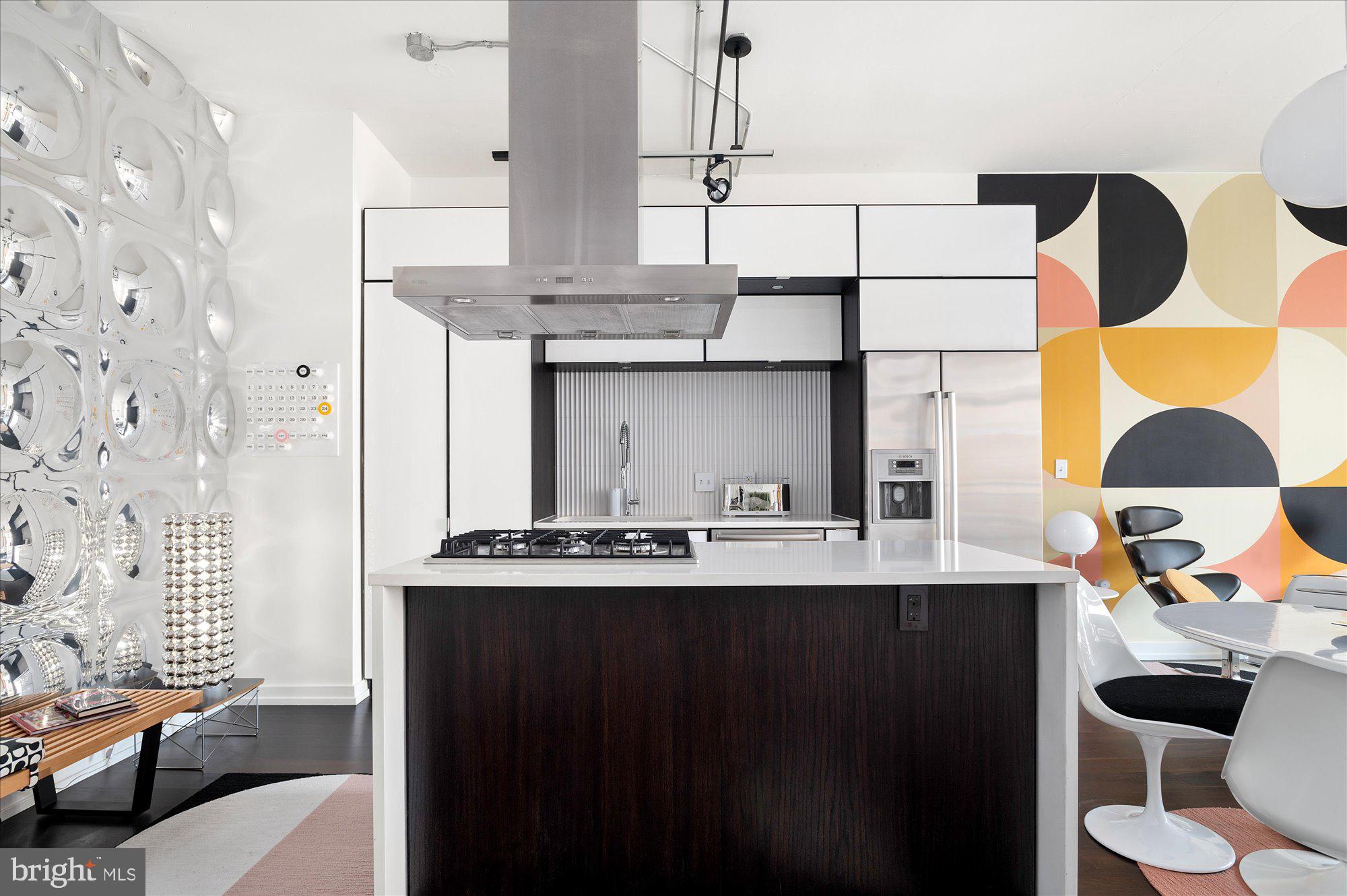 1515 15th Street Northwest, Unit 602 Washington, DC 20005 - Photo 2 of 30 a kitchen with a sink a stove and a wooden floor