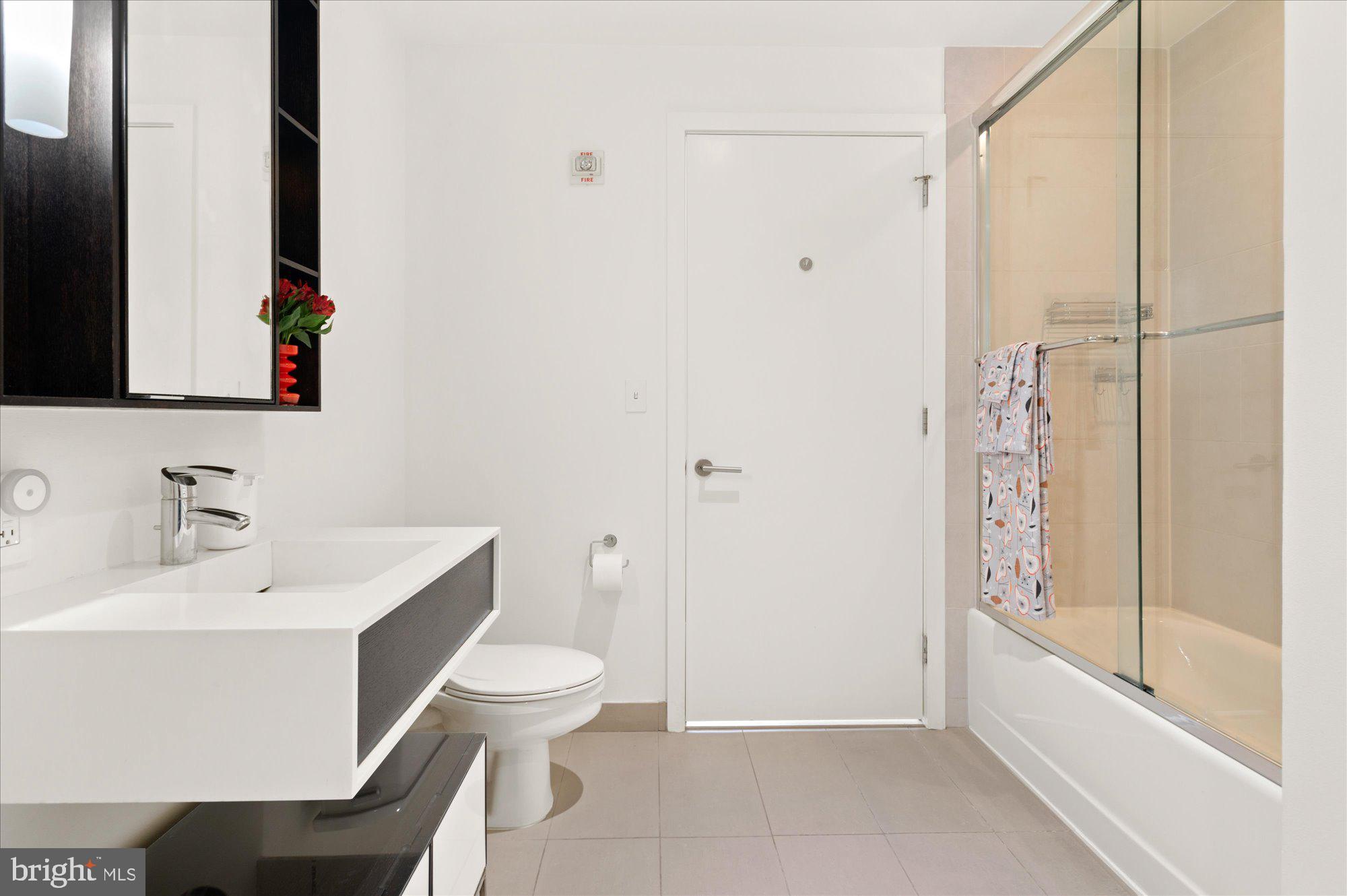 1515 15th Street Northwest, Unit 602 Washington, DC 20005 - Photo 22 of 30 a bathroom with a sink toilet and shower