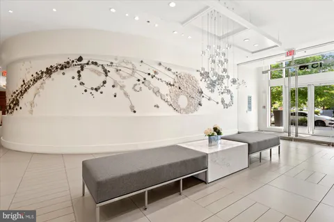 a living room with furniture a chandelier and a chandelier