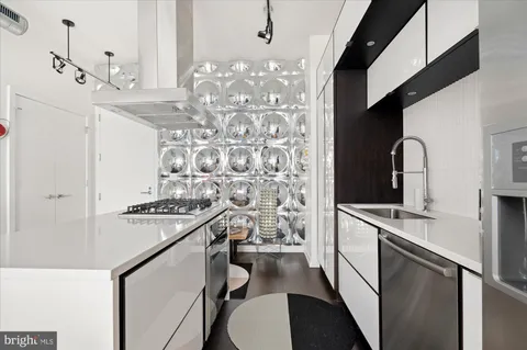 a kitchen with cabinets a sink stove and refrigerator