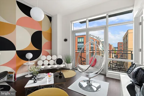 a living room with furniture and a floor to ceiling window