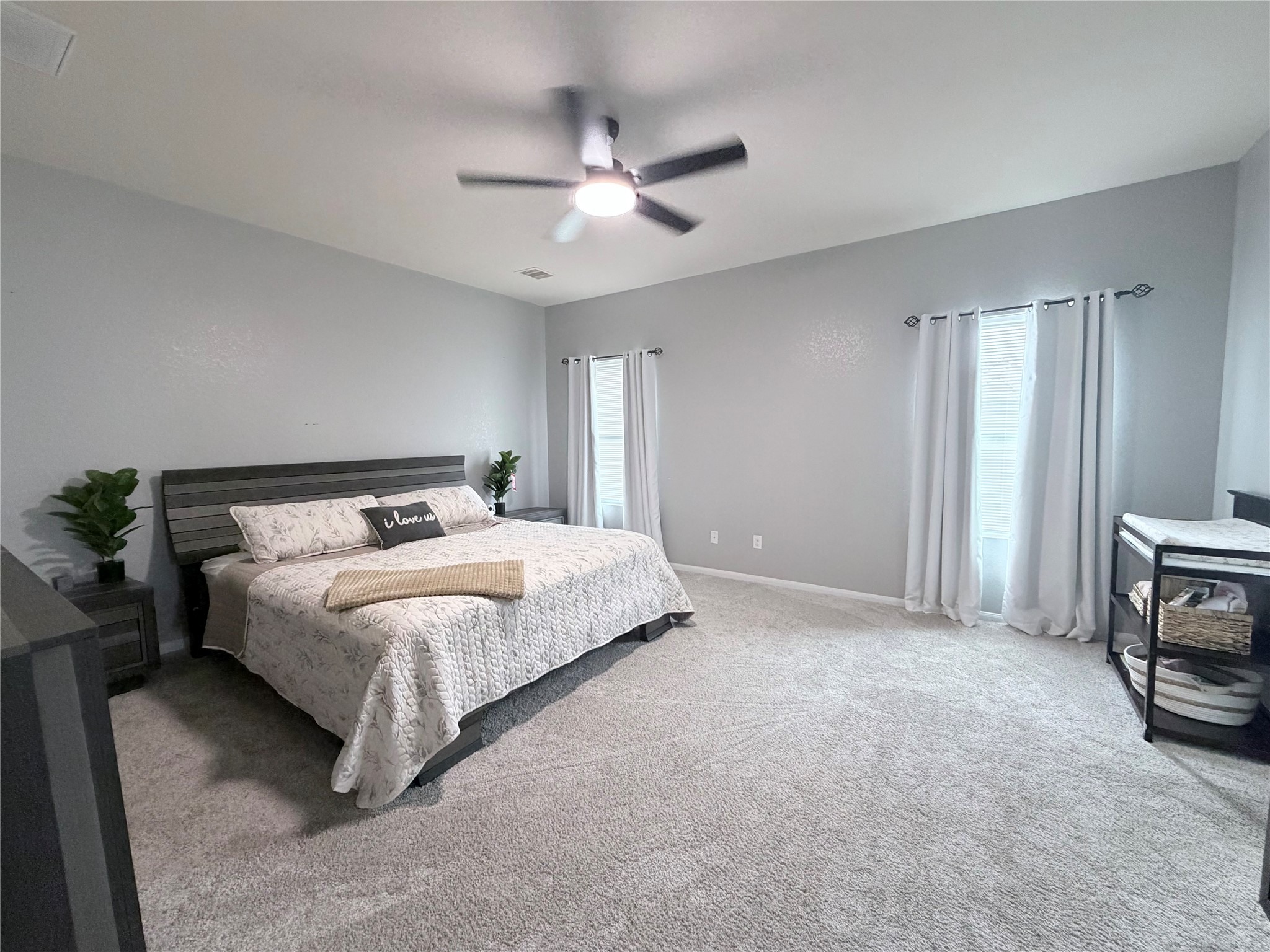 3226 Dappled Vale Trail Spring, TX 77373 - Photo 23 of 26 This spacious bedroom features neutral walls, plush carpeting, and ample natural light from large windows.