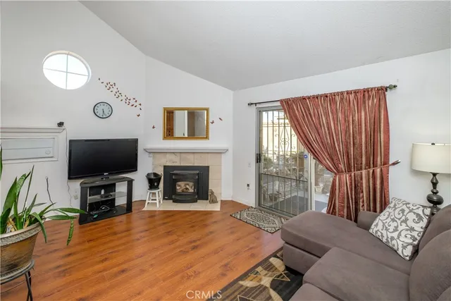 a living room with furniture a fireplace and a flat screen tv