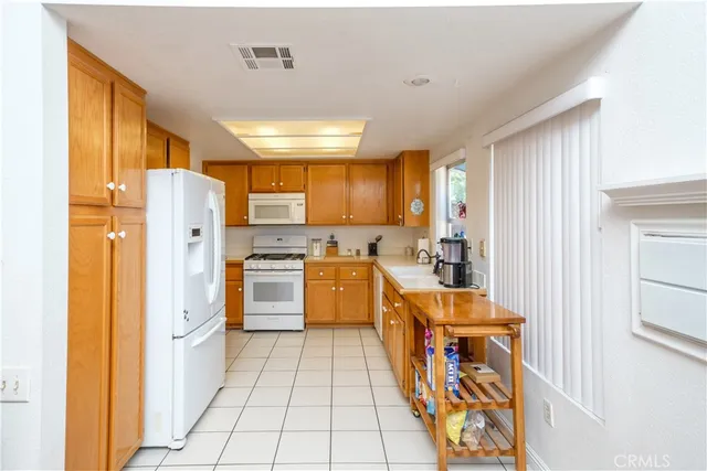 a kitchen with stainless steel appliances granite countertop a refrigerator and a stove