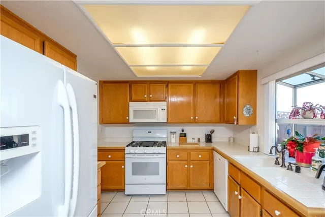 a kitchen with a sink a stove and cabinets