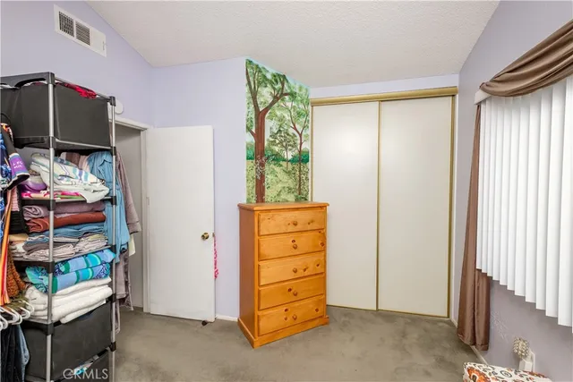 a backyard of a house with a tree and plants