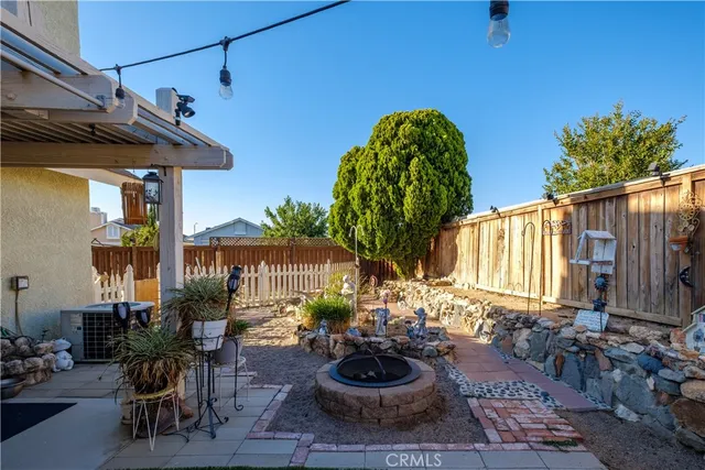 a view of a house with a small yard and wooden fence