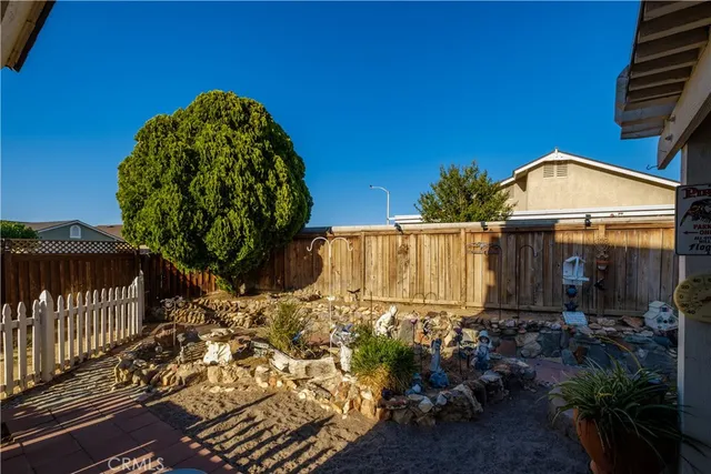 a view of a backyard with table and chairs with wooden floor