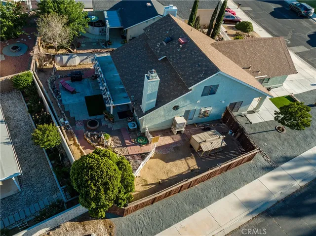 an aerial view of a house with garden space and sitting area