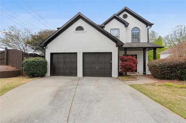 a view of a house with a yard and garage