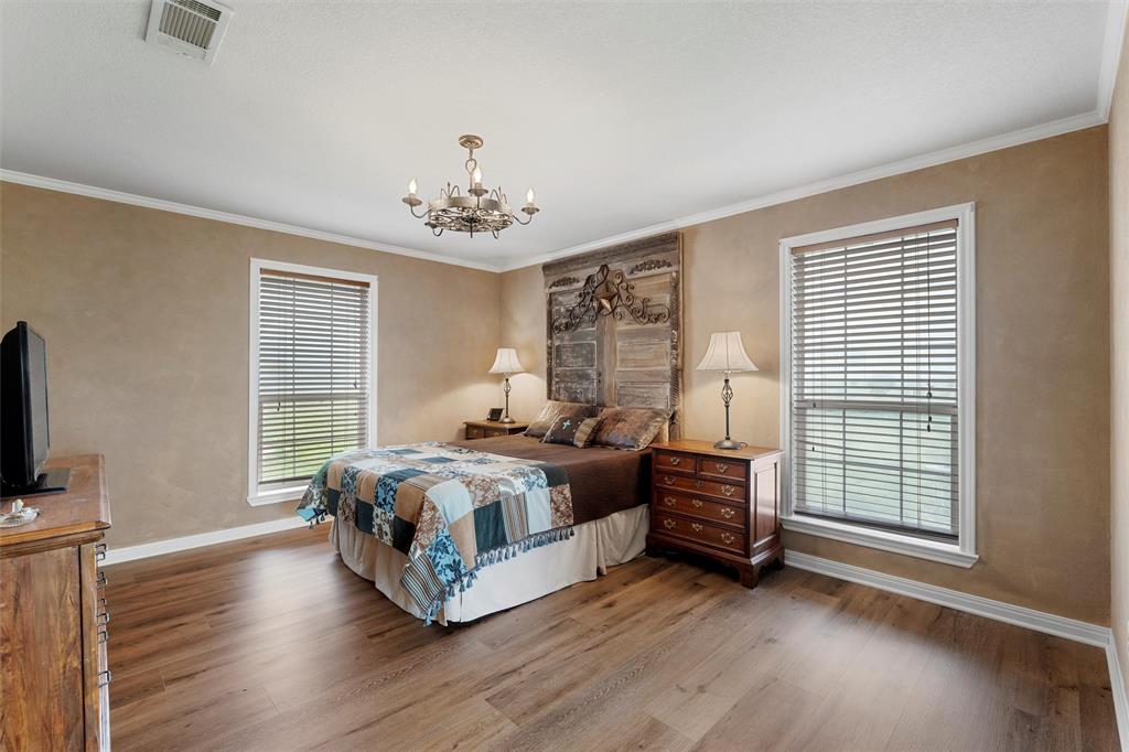 3057 Holy Road Abbott, TX 76621 - Photo 24 of 39 a spacious bedroom with a bed and a tv on table
