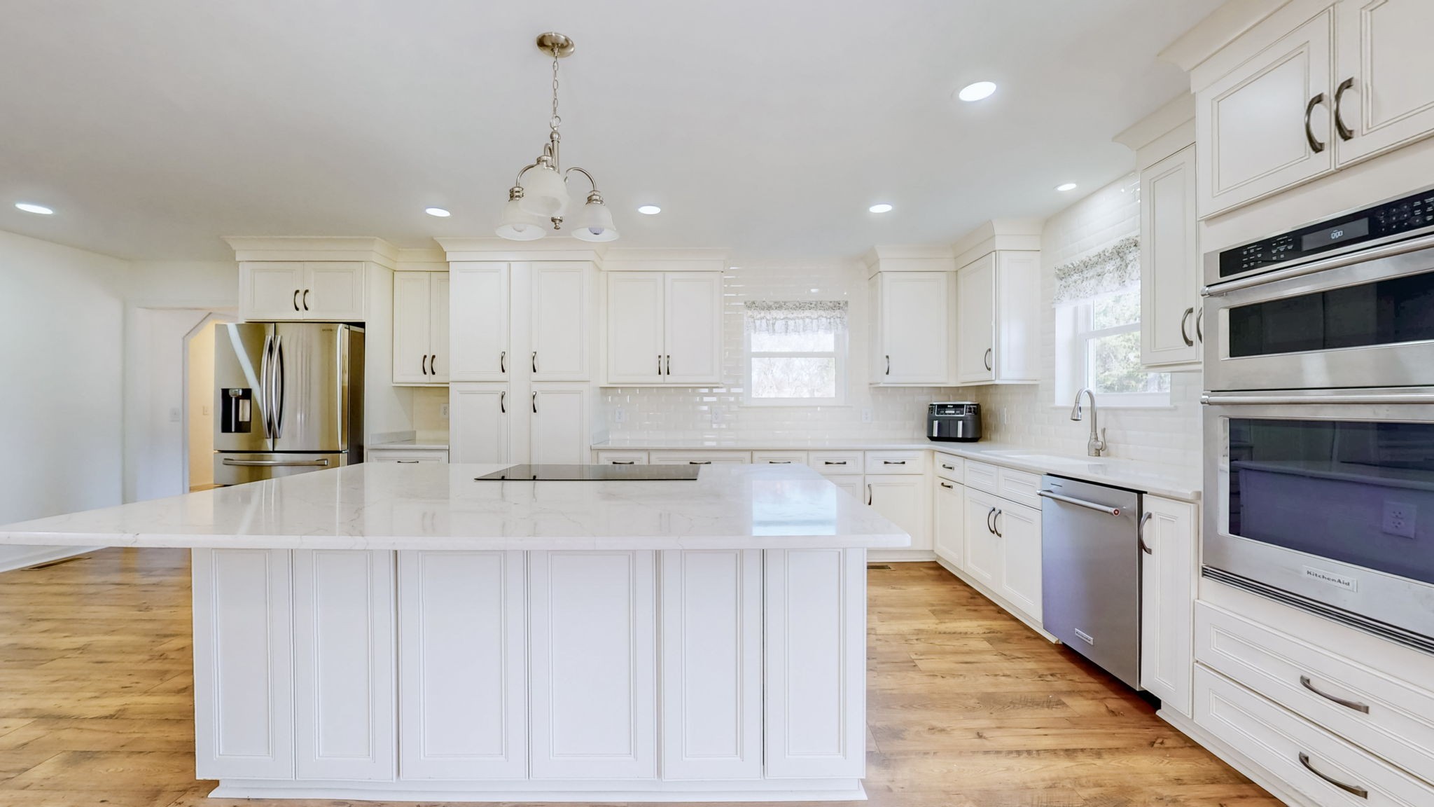120 3 Fork Bridge Road Wartrace, TN 37183 - Photo 12 of 48 a large kitchen with granite countertop a stove top oven a sink dishwasher and a refrigerator with wooden floor