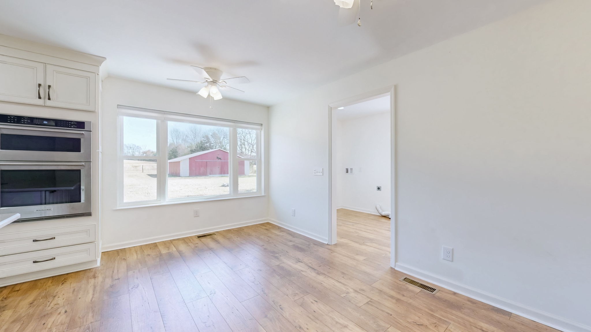 120 3 Fork Bridge Road Wartrace, TN 37183 - Photo 14 of 48 an empty room with wooden floor fireplace and windows