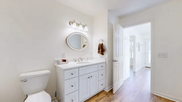 a kitchen with stainless steel appliances white cabinets and wooden floor