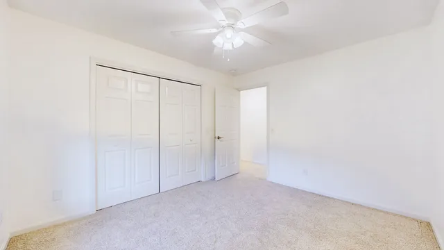 a bathroom with a sink a toilet a large mirror and vanity