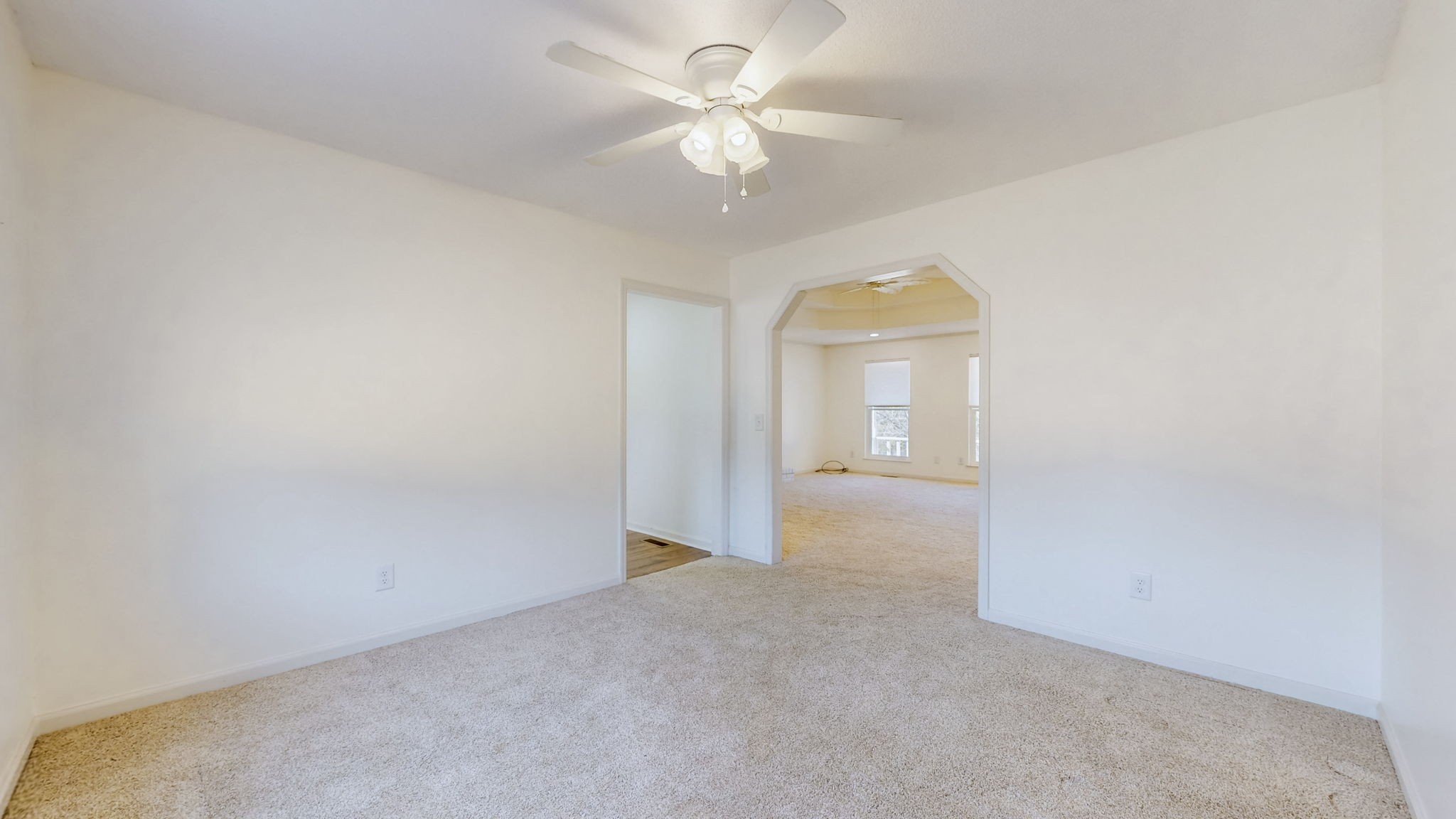 120 3 Fork Bridge Road Wartrace, TN 37183 - Photo 9 of 48 an empty room with a chandelier fan and a window