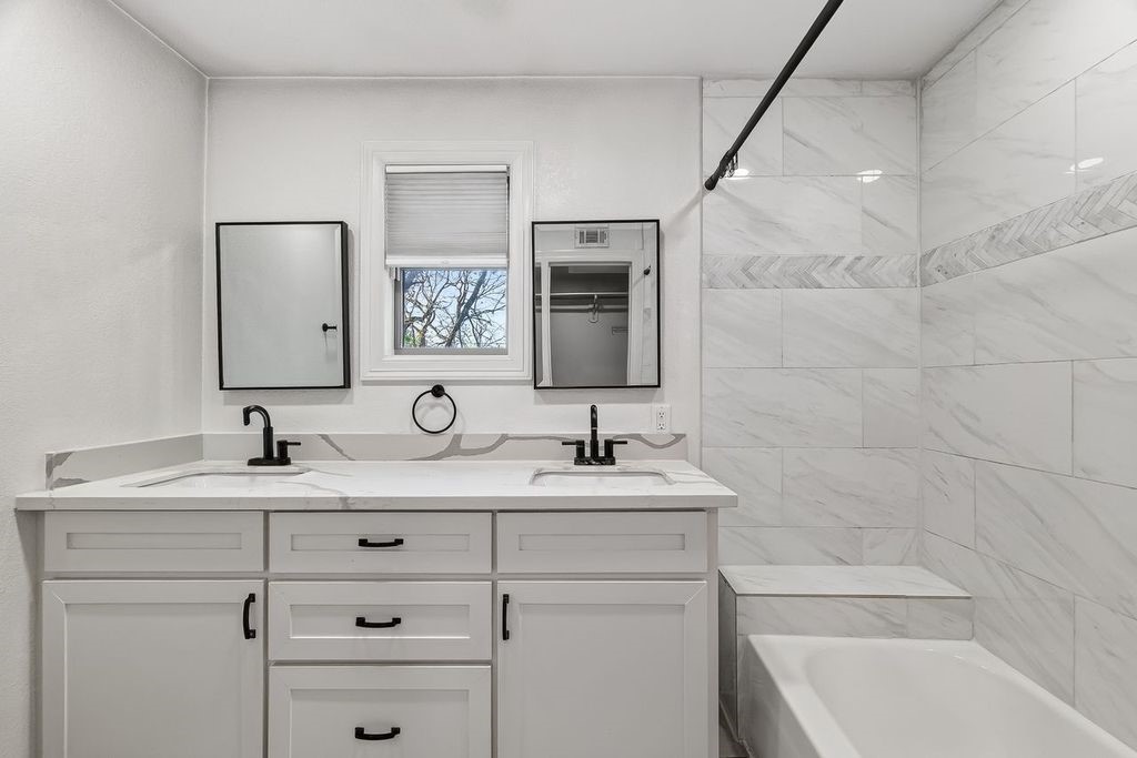 4520 Sharon Street Houston, TX 77020 - Photo 8 of 15 Primary bathroom includes double sinks and a relaxing soaking tub for a spa-like feel.