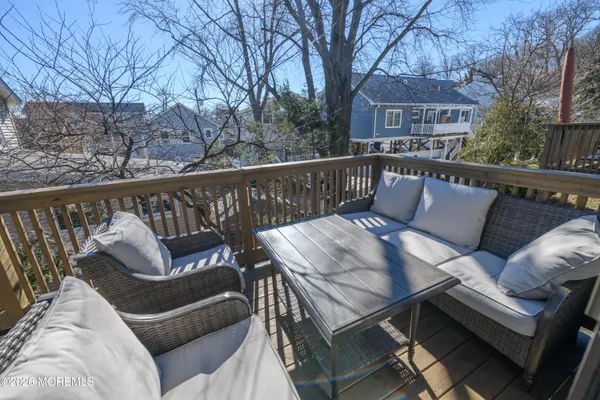 a roof deck with couches and wooden fence