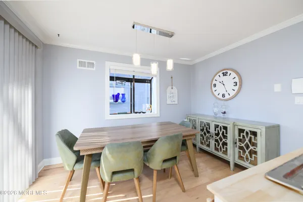 a dining room with a wooden table and chairs