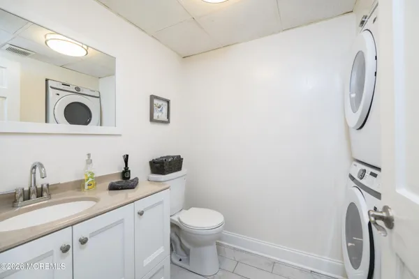 a bathroom with a granite countertop toilet sink and mirror