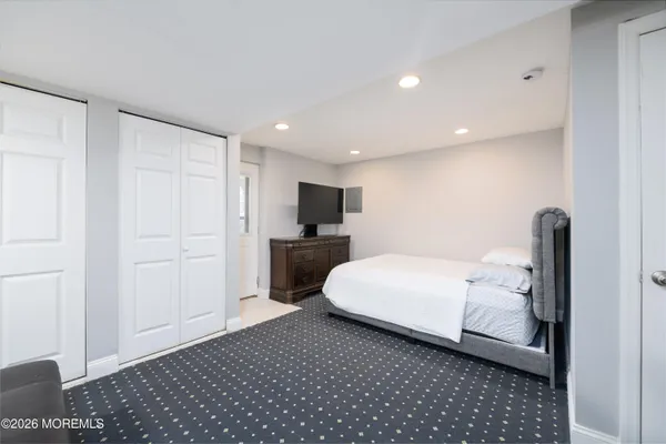 a room with a bed and a view of kitchen