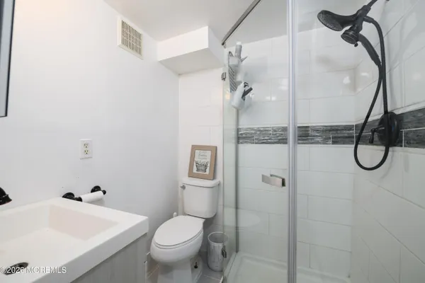 a bathroom with a granite countertop toilet sink and shower