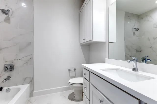 a bathroom with a sink a toilet and bathtub