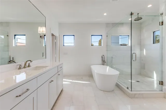 a bathroom with a double sink sink and shower