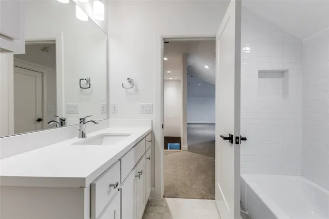 a bathroom with a sink a mirror and a bathtub