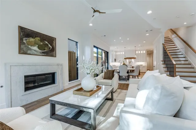 a living room with furniture a fireplace and a kitchen