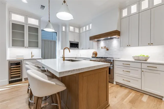 a kitchen with a stove a sink and a refrigerator