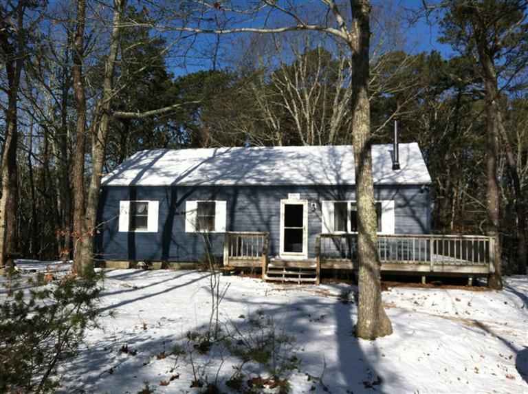 120 Pine Needle Road Wellfleet, MA 02667 - Photo 1 of 15 a front view of a house with a yard