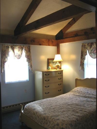 120 Pine Needle Road Wellfleet, MA 02667 - Photo 7 of 15 a bedroom with a bed and window