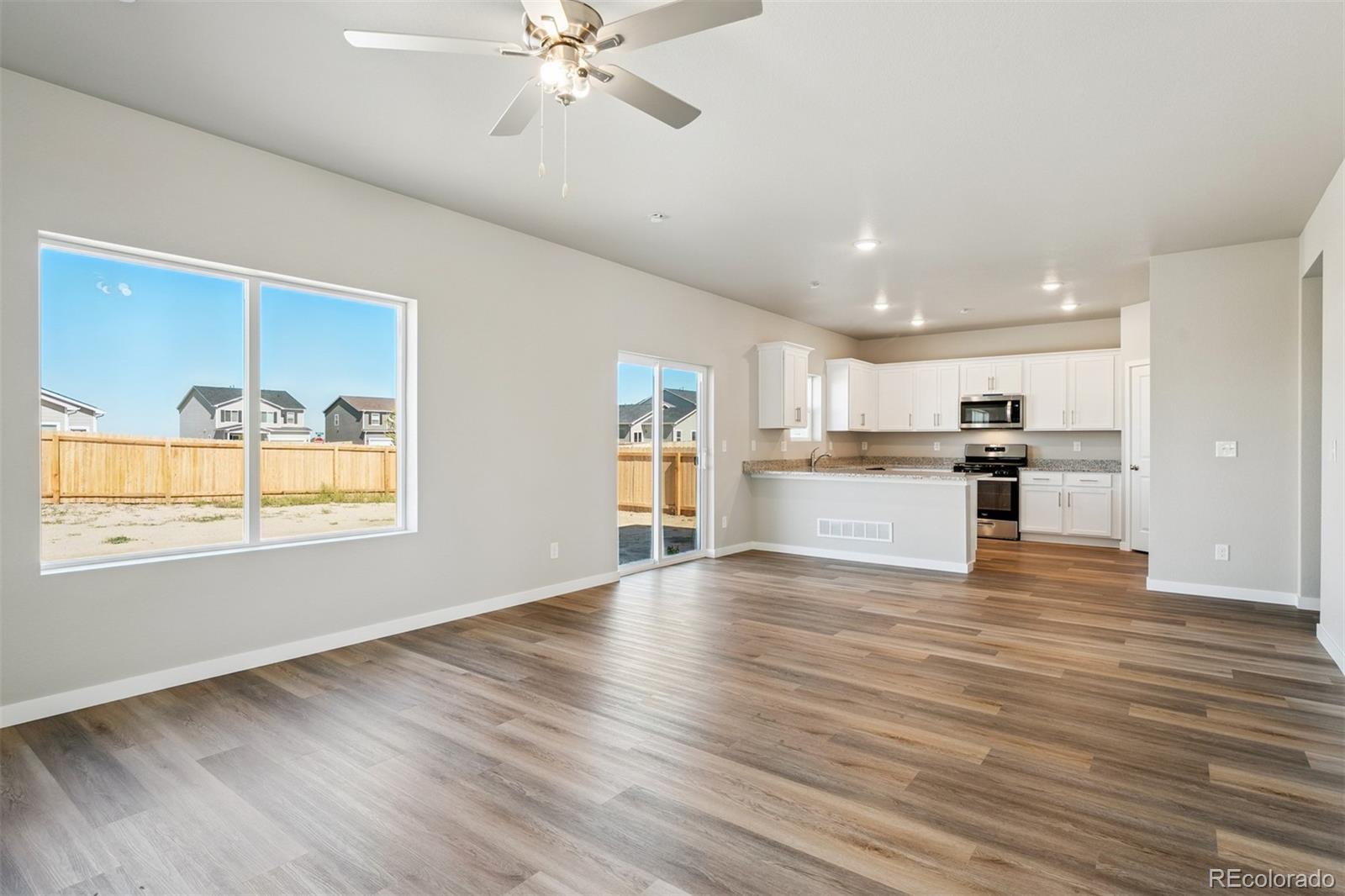 2181 Christina Street Fort Lupton, CO 80621 - Photo 5 of 39 a view of a kitchen with wooden floor and a kitchen