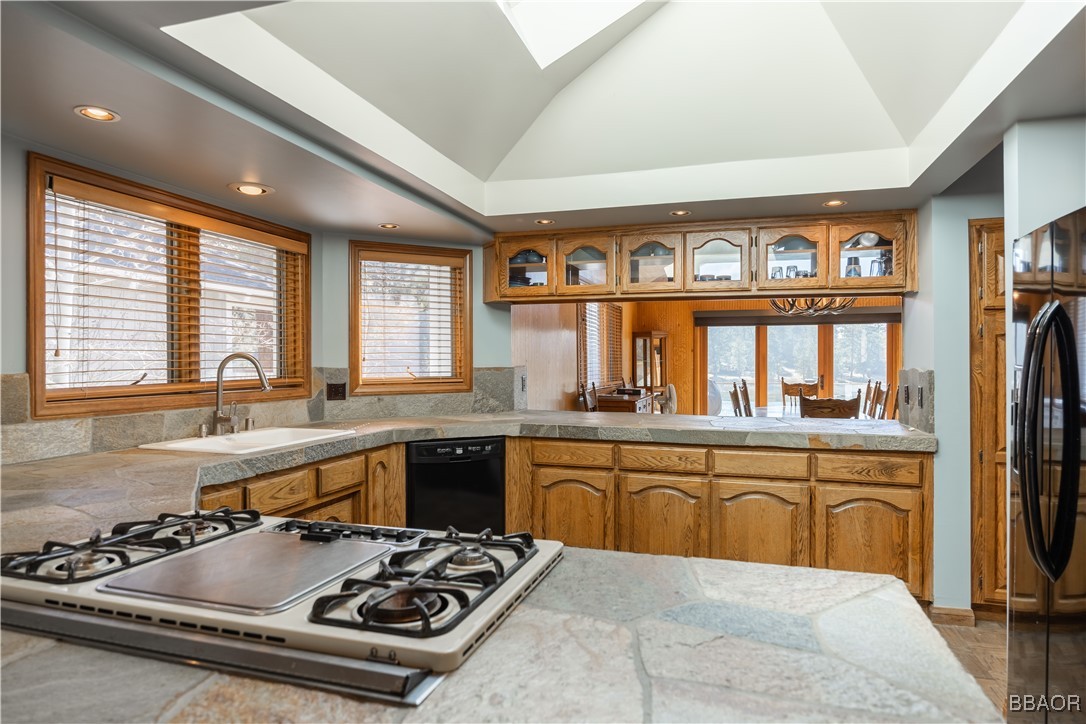 599 Cove Drive Big Bear Lake, CA 92315 - Photo 12 of 50 a kitchen with furniture a sink and stainless steel appliances