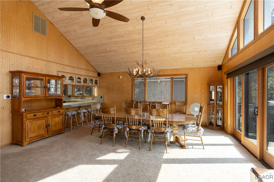 599 Cove Drive Big Bear Lake, CA 92315 - Photo 16 of 50 a outdoor space with lots of tables a mirror and chandelier