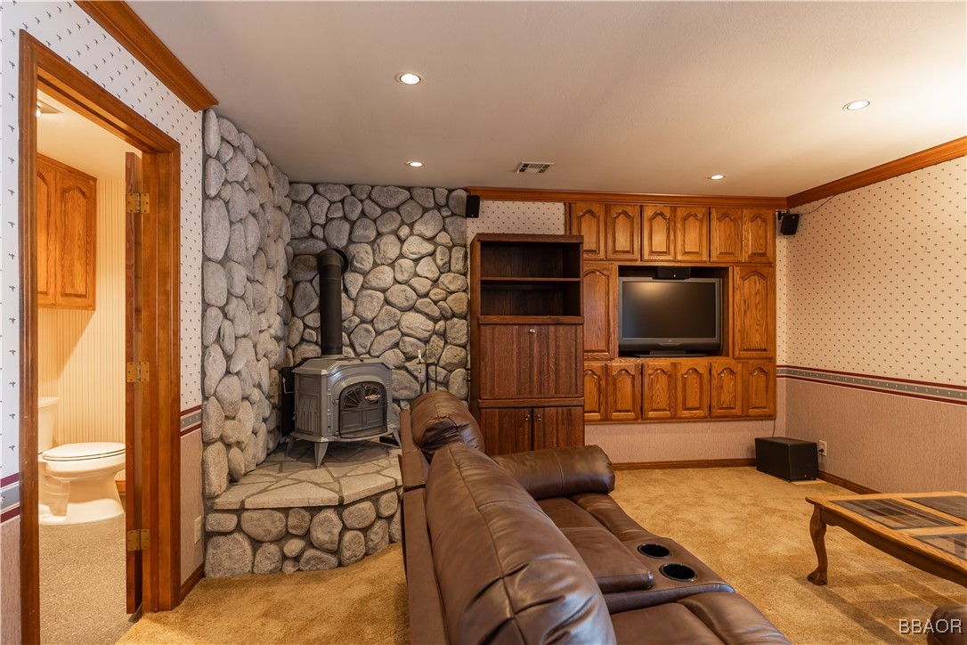599 Cove Drive Big Bear Lake, CA 92315 - Photo 22 of 50 a living room with furniture and a flat screen tv
