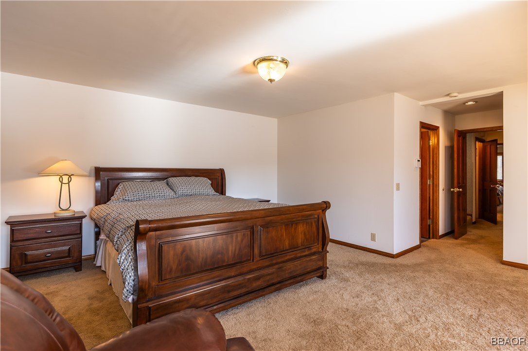 599 Cove Drive Big Bear Lake, CA 92315 - Photo 25 of 50 a bedroom with a bed and a lamp