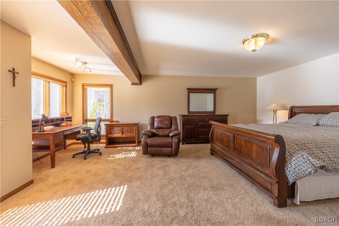 599 Cove Drive Big Bear Lake, CA 92315 - Photo 26 of 50 a bedroom with furniture and a chandelier