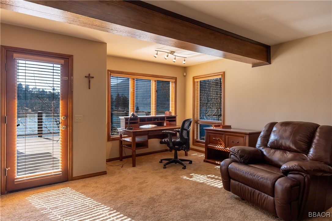 599 Cove Drive Big Bear Lake, CA 92315 - Photo 27 of 50 a living room with furniture a desk and chair with windows