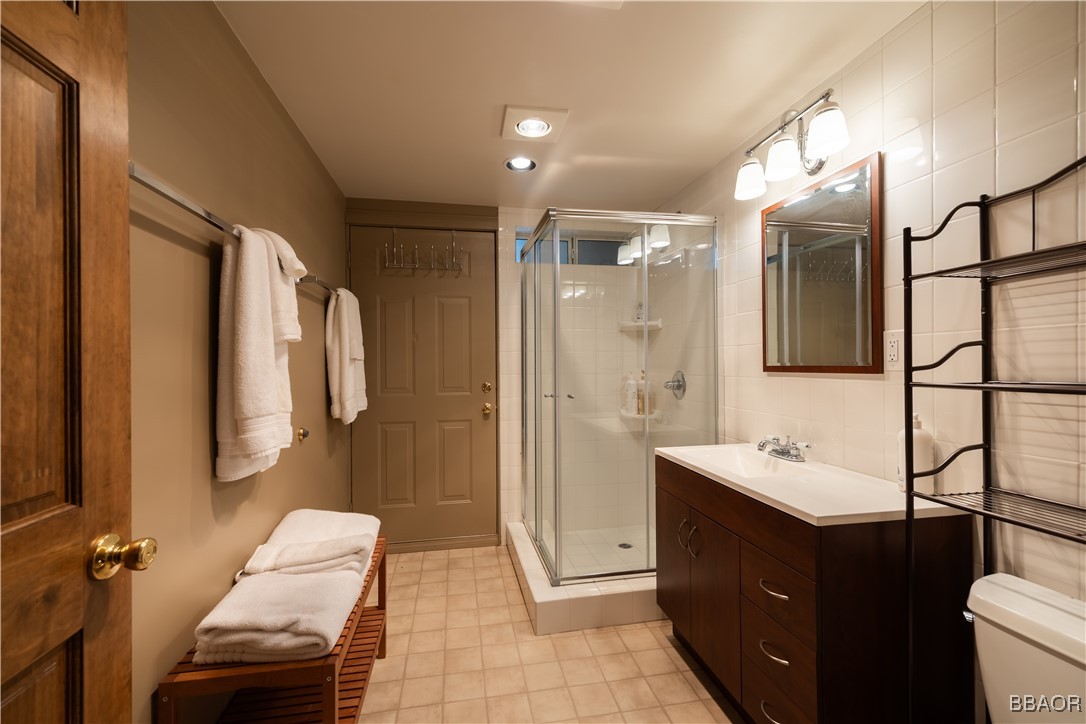 599 Cove Drive Big Bear Lake, CA 92315 - Photo 32 of 50 a bathroom with a sink a toilet and mirror