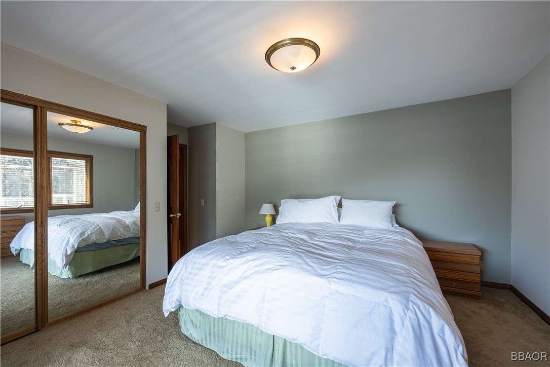 599 Cove Drive Big Bear Lake, CA 92315 - Photo 35 of 50 a bedroom with a bed and window