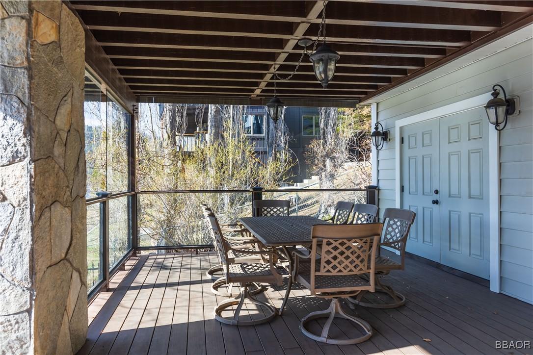 599 Cove Drive Big Bear Lake, CA 92315 - Photo 36 of 50 a balcony with table and chairs