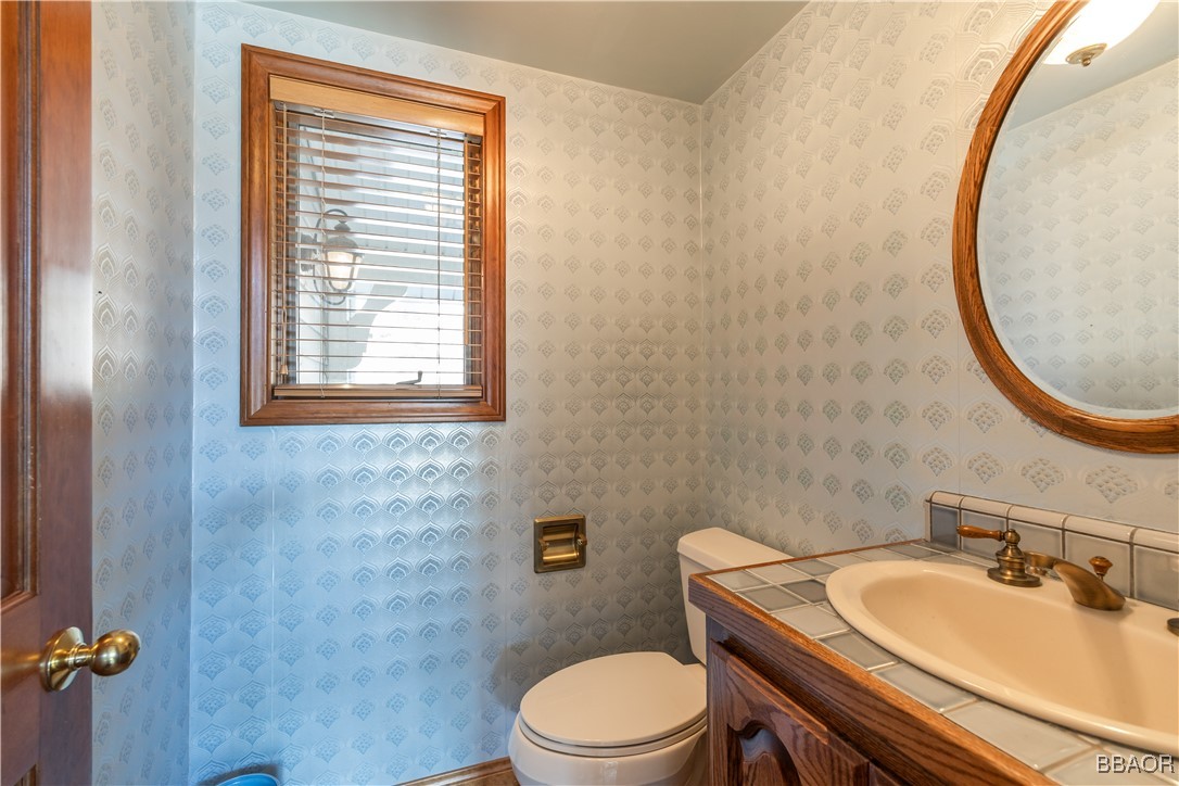 599 Cove Drive Big Bear Lake, CA 92315 - Photo 40 of 50 a bathroom with a sink a toilet and a mirror