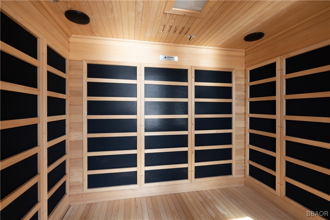 599 Cove Drive Big Bear Lake, CA 92315 - Photo 43 of 50 a view of an empty room with a large window and wooden floor