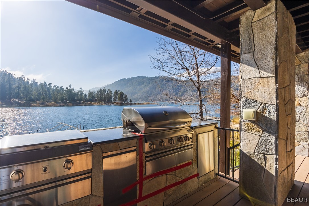 599 Cove Drive Big Bear Lake, CA 92315 - Photo 44 of 50 a view of a lake with couches and wooden floor