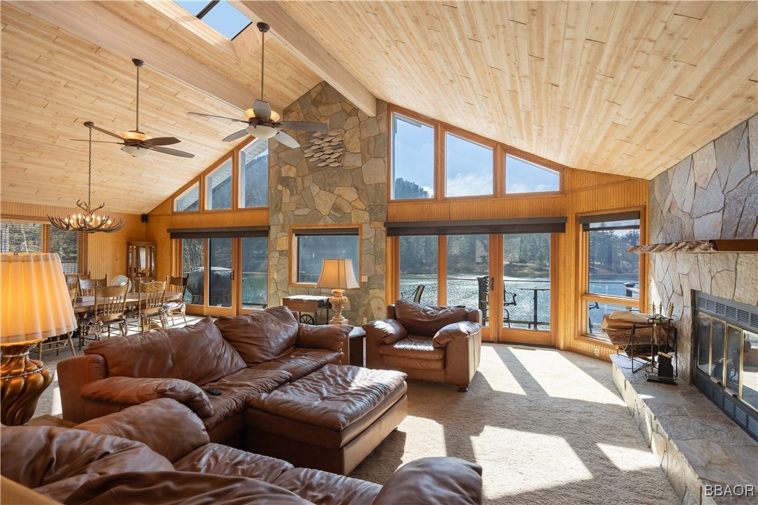 599 Cove Drive Big Bear Lake, CA 92315 - Photo 5 of 50 a living room with furniture a fireplace and a chandelier