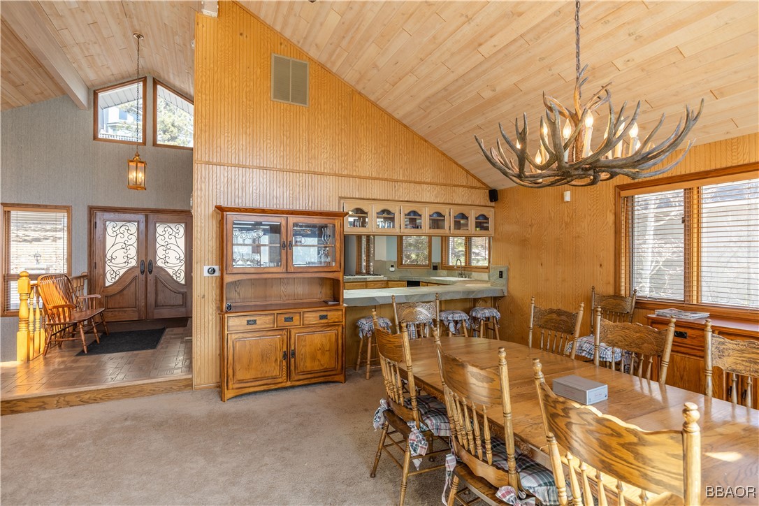 599 Cove Drive Big Bear Lake, CA 92315 - Photo 8 of 50 a view of a dining room with furniture and a chandelier