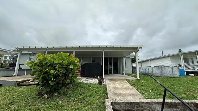 a view of a house with a garden and plants